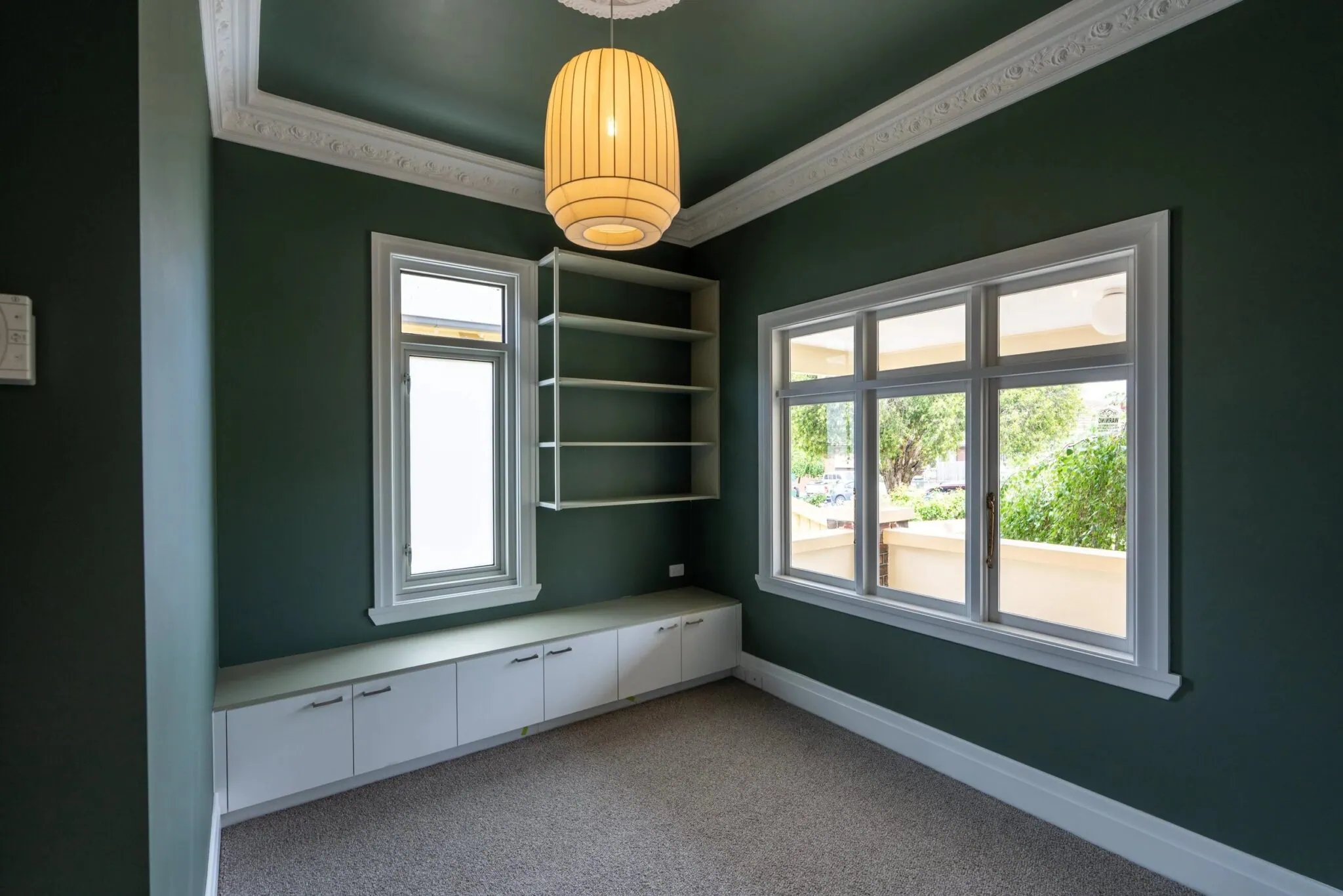 Restored period room with ornate ceiling cornices and built-in joinery in a Melbourne home renovation by Quickset Carpentry
